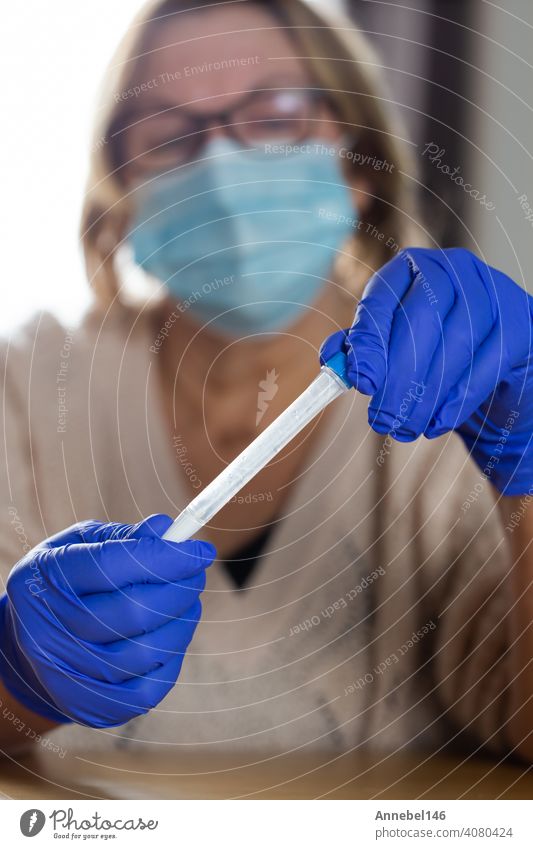 Senior woman studying and taking the self test for Covid-19, home test kit for coronavirus health pandemic swab epidemic disease patient medical equipment