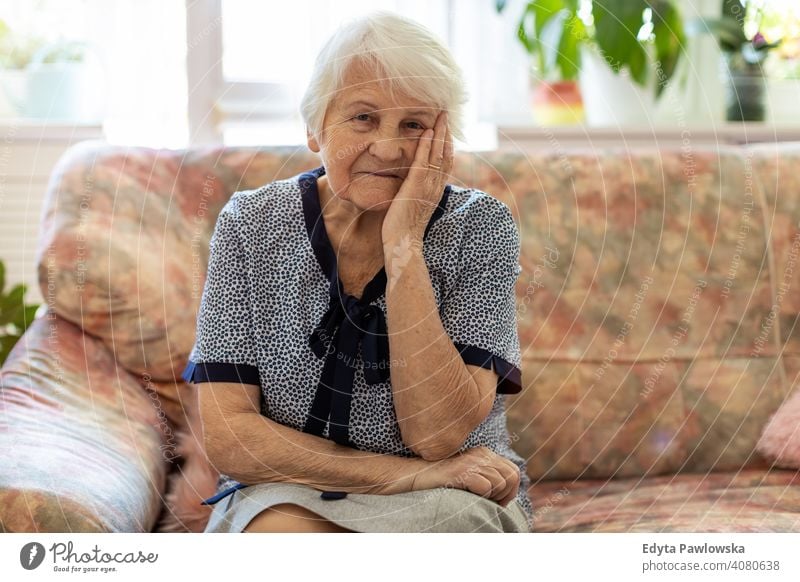 Portrait of an elderly woman in a state of worry at home sad lonely unhappy depression uncertainty anxiety worried grief sadness loss problem crisis serious