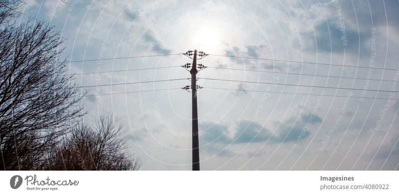 High voltage power line against blue sky with clouds, Rhineland-Palatinate, Germany. High voltage pylons, power line tower, alternative energy, new natural landscape