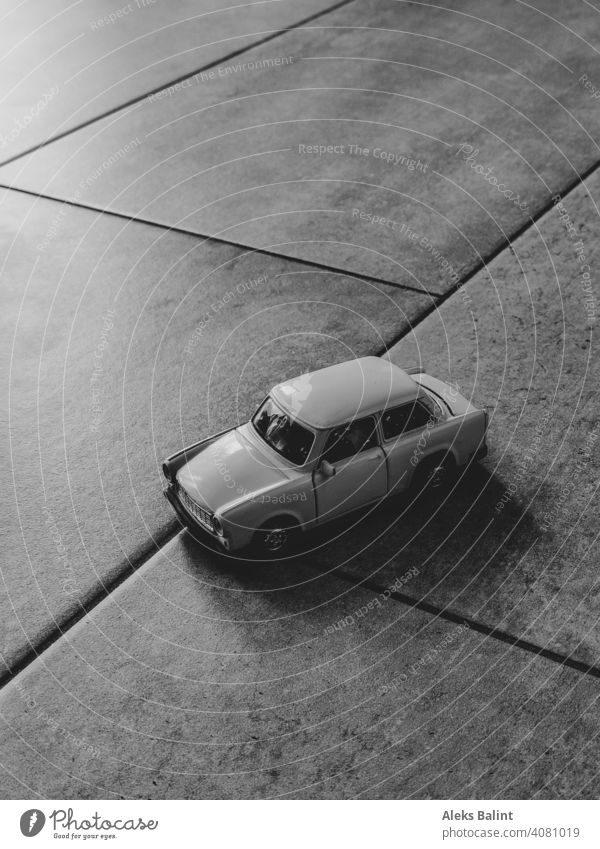 Toy car on tiles Toys Infancy trobant Trabbi Black & white photo Car GDR Playing Vehicle