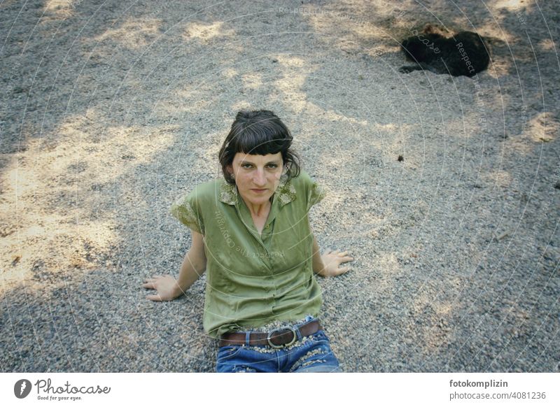 Woman sitting on gravel floor Easygoing Gravel Meditative Identity Reflected Serene Feminine Break Earth Sit critical being out Loneliness Playground Beach