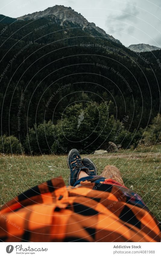 Crop traveler lying near mountain tourist valley landscape nature peak view relax countryside rock scenic range ridge journey environment calm tranquil serene