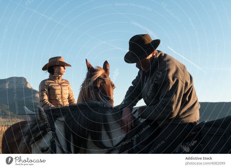 People riding horses people ranch sunset sky evening man woman gesture sport horseback equestrian lifestyle leisure recreation domestic fun animal creature joy