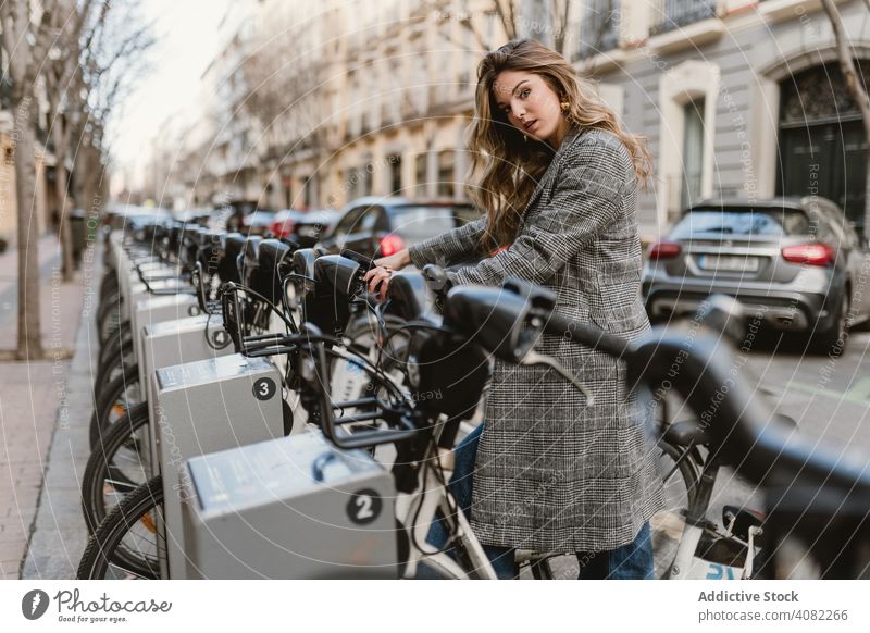 Lady choosing rental bicycle on parking lot public elegant weekend leisure road joy outdoors journey lady trip woman lifestyle transport vacation female