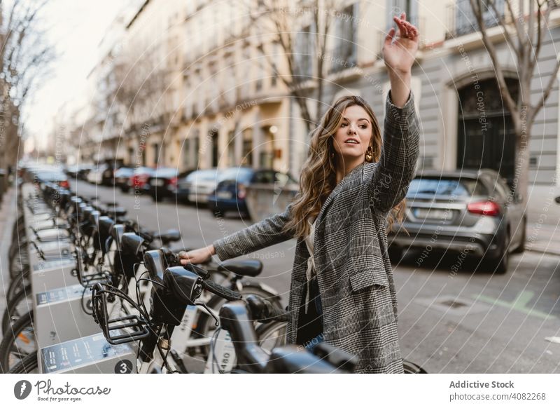 Lady choosing rental bicycle on parking lot public elegant weekend leisure road joy outdoors journey lady trip woman lifestyle transport vacation female