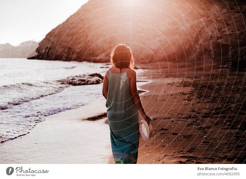 young beautiful woman walking by the beach at sunset. Relax and holidays concept cute model shore fresh light tourism motion sunlight shine freedom romantic