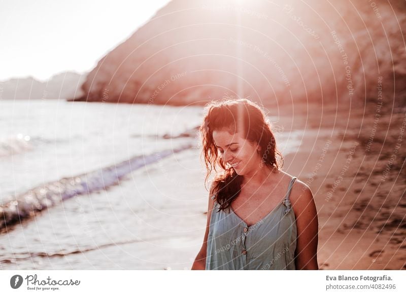 young beautiful woman walking by the beach at sunset. Relax and holidays concept cute model shore fresh light tourism motion sunlight shine freedom romantic