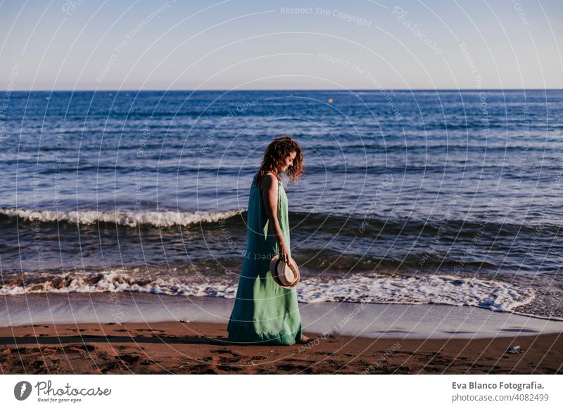 young beautiful woman walking by the beach at sunset. Relax and holidays concept cute model shore fresh light tourism motion sunlight shine freedom romantic