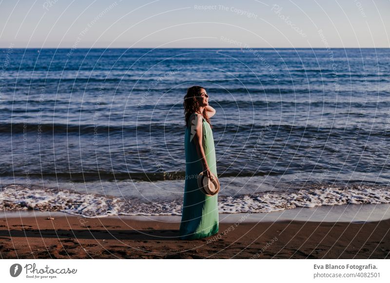 young beautiful woman walking by the beach at sunset. Relax and holidays concept cute model shore fresh light tourism motion sunlight shine freedom romantic