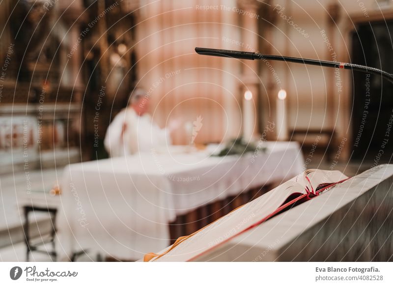 unrecognizable Priest during a wedding ceremony nuptial mass. Religion concept. Selective focus jesus ritual protestant modern divine cup eucharist goblet