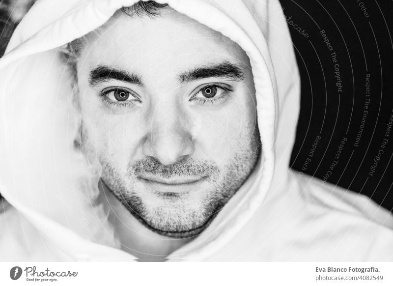 Portrait of a young man smoking, studio shooting, black and white , close up view. led ring reflection in the eyes head dark people male cigarette bad inhaling