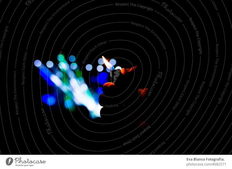 man hand holding a lighter in a night concert performance. Fun and lifestyle outdoors fan people live performer happy music mobile phone dance crowd young