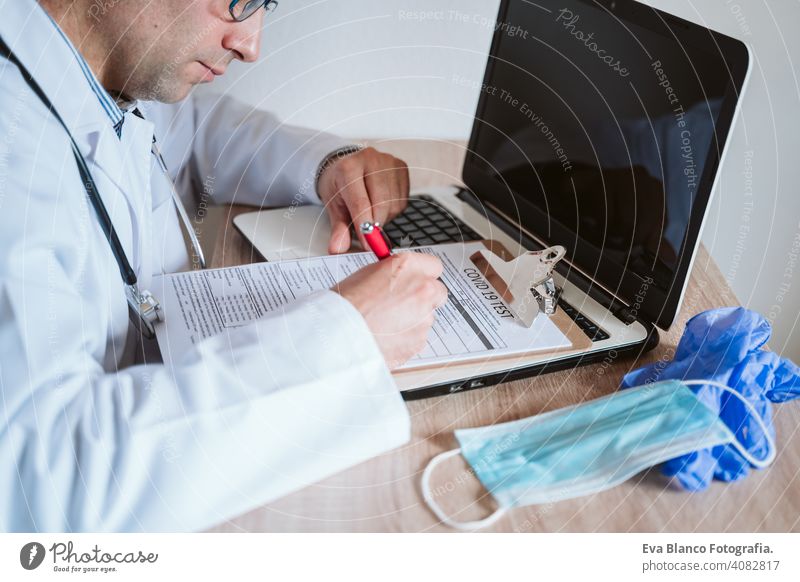 doctor man working on laptop. Corona virus test on table. Covid-19 concept corona virus covid-19 protective gloves protective mask technology analysis vaccine