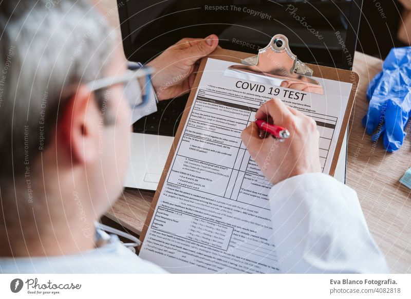 doctor man working on laptop. Corona virus test on table. Covid-19 concept corona virus covid-19 protective gloves protective mask technology analysis vaccine