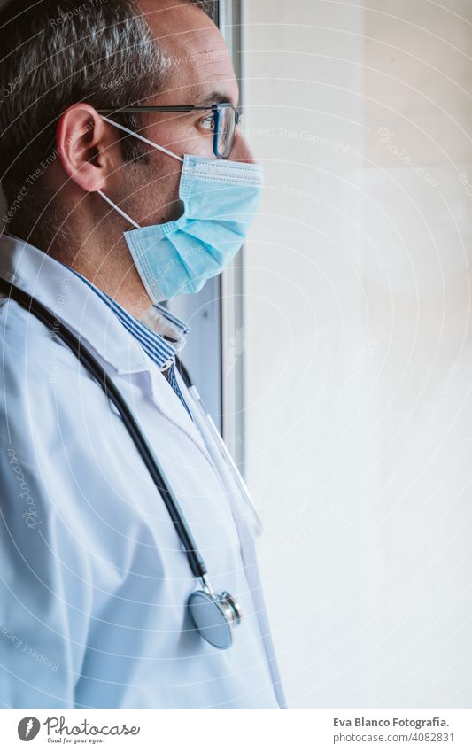 doctor man wearing protective mask , stethoscope and gloves indoors. Corona virus concept portrait professional corona virus hospital working infection safety