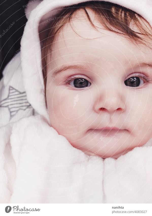 Lovely portrait of a baby girl wearing winter clothes infancy cute little face eyes gray eyes newborn parenthood child cutie lovely adorable cozy pose