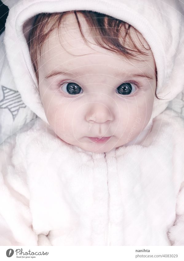 Lovely portrait of a baby girl wearing winter clothes infancy cute little face eyes gray eyes newborn parenthood child cutie lovely adorable cozy pose