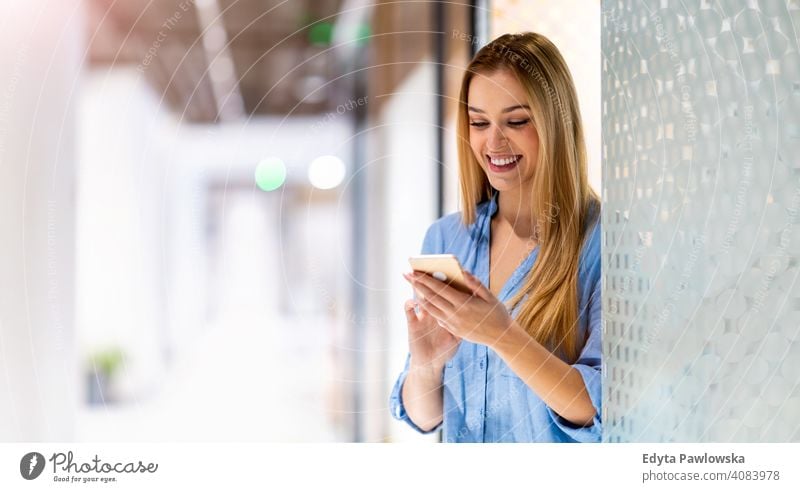 Young businesswoman using mobile phone in her office girl people Entrepreneur successful professional young adult female lifestyle indoors millennial attractive