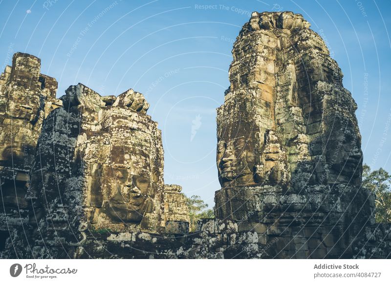 Stone statues near ancient temple stone weathered sunny daytime architecture oriental angkor wat religion travel sculptures row monument culture old aged shabby