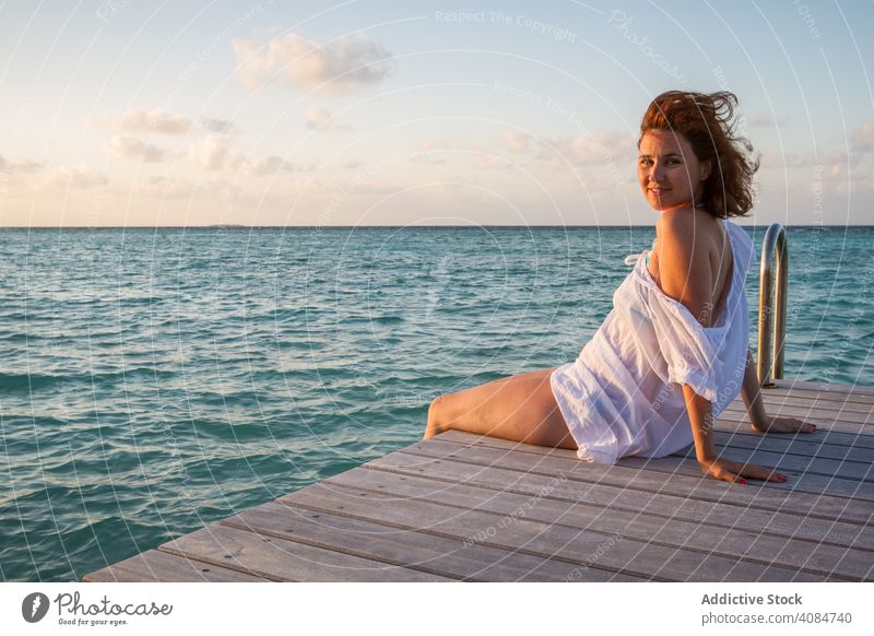 Young woman on pier near sea portrait beautiful relax attractive tourism lifestyle horizontal female copy space trip pretty vacation maldives idyllic harmony