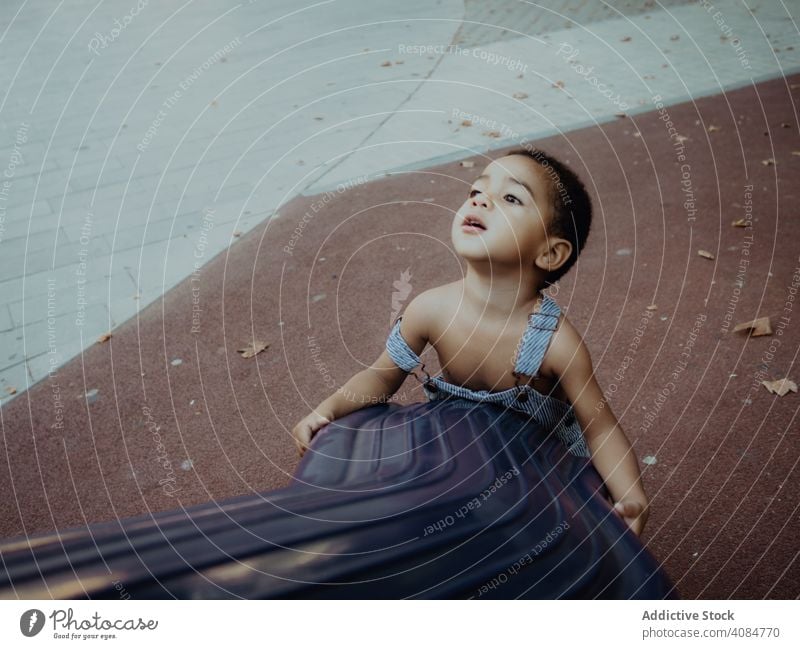 funny boy playing in a playground outdoors horizontal joyful child casual attractive park happiness adorable activity young beautiful childhood lifestyle kid