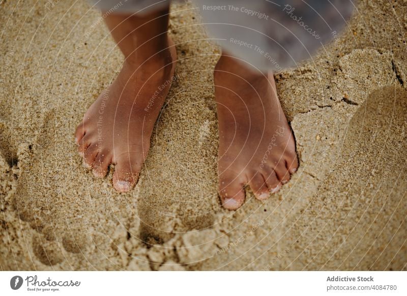 Crop black kid standing on sand legs summer beach barefoot little wet lifestyle leisure child rest relax ethnic african american vacation shore coast innocence