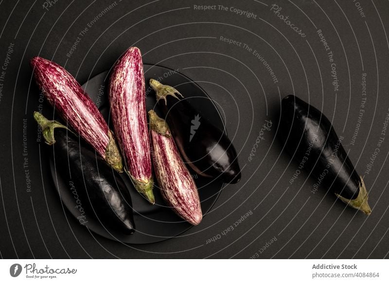 Ripe eggplants on black tabletop fabric ripe fresh rustic food healthy vegetable vegan ingredient raw diet cloth napkin weathered shabby grungy agriculture