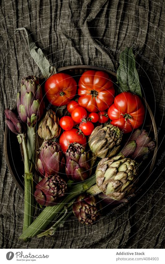 Assorted vegetables and napkins on table kitchen ingredients assortment food cuisine salad fabric cloth bowl dinner lunch meal variety tomatoes artichokes