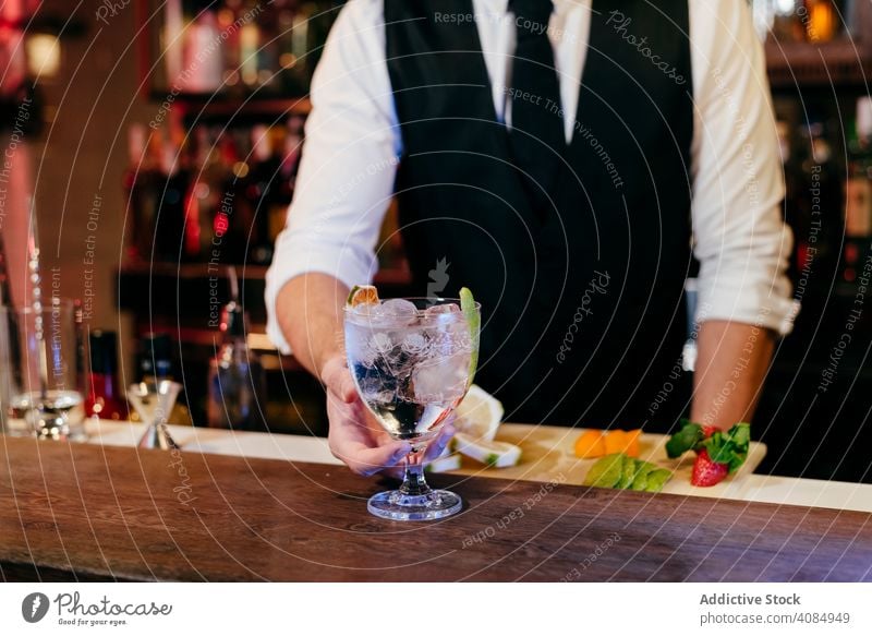 Barman working making drinks barman pineapple glass bartender caucasian pouring cocktail tie elegant celebration shaker hospitality luxury preparing party