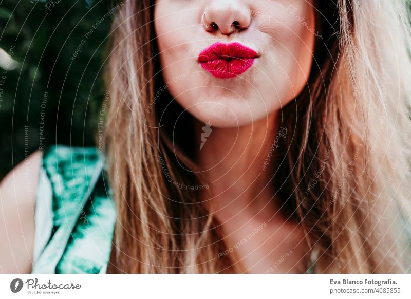 unrecognizable blonde young woman kissing at sunset. Red lips. Happiness and lifestyle concept caucasian hair toothy cute happy girl pretty health summer model