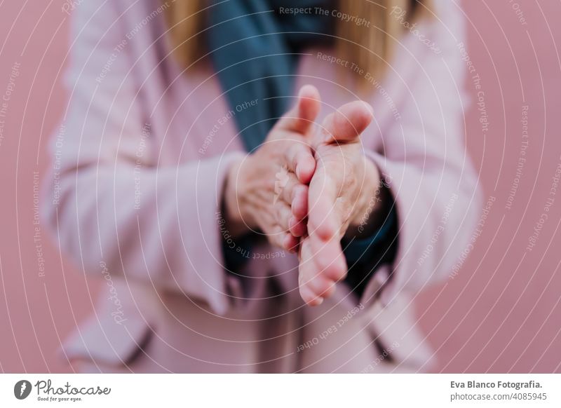 caucasian woman in the street using an alcohol gel or antibacterial disinfectant on hands. Hygiene and corona virus concept soap mask outdoors public adult