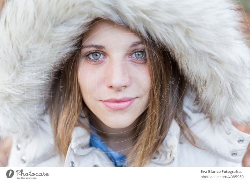 outdoors portrait of a beautiful young woman looking at the camera. Woman posing in autumn. sunset happy girl lifestyle beauty fashion coat nature close up park