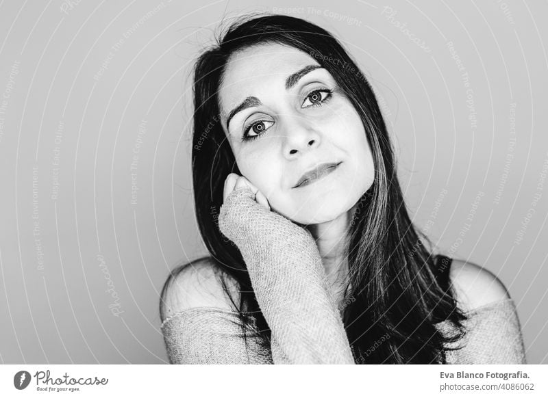 portrait indoors of a young beautiful woman with led ring reflection in her eyes. Black and white photography stylish style makeup studio flash background