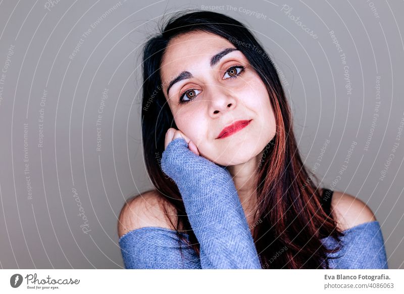 portrait indoors of a young beautiful woman with led ring reflection in her eyes. stylish style makeup studio flash background fashion led lamp make up