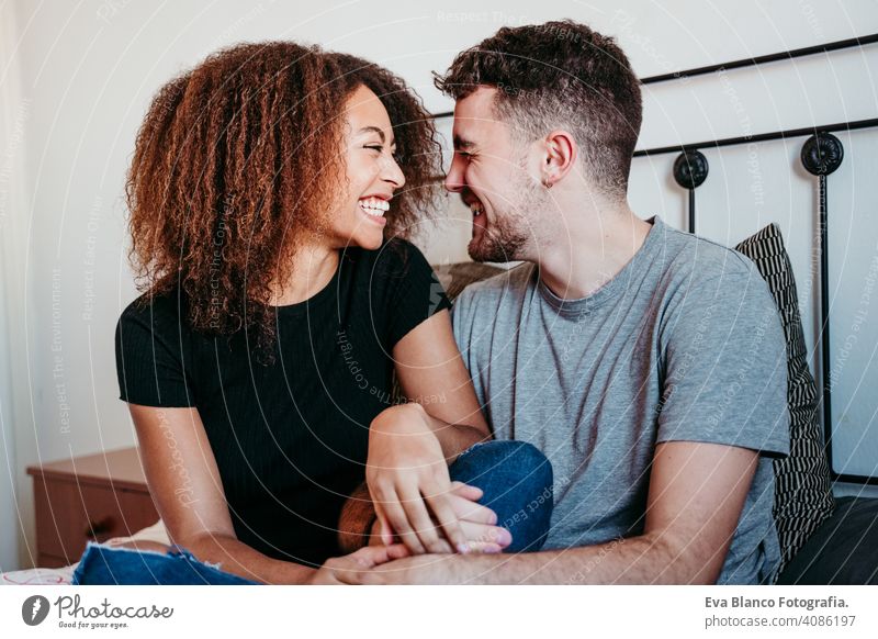 happy couple in love at home. Afro american woman and caucasian man. ethnic love concept afro american bed indoors valentine mixed race february smile cute