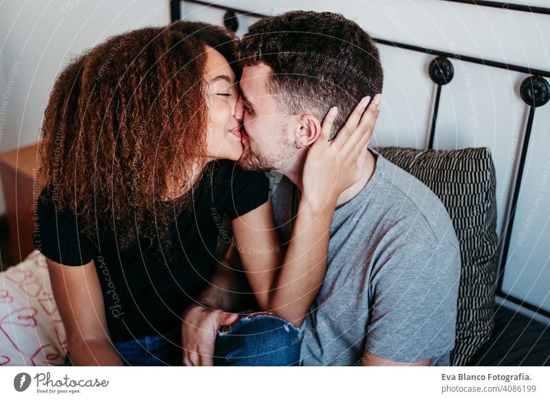 happy couple in love at home. Afro american woman and caucasian man. ethnic love concept afro american bed indoors valentine mixed race february smile cute