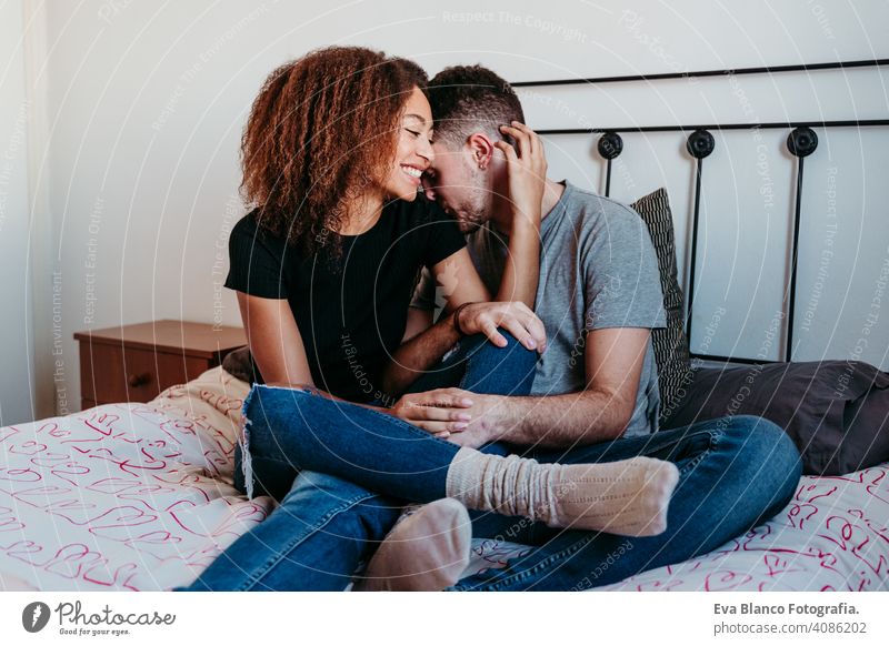 happy couple in love at home. Afro american woman and caucasian man. ethnic love concept afro american bed indoors valentine mixed race february smile cute