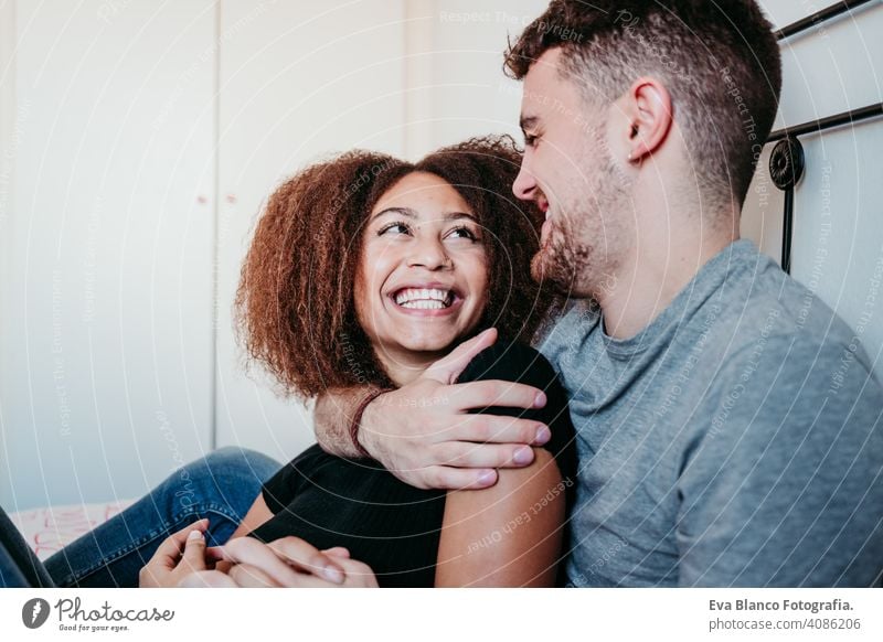 happy couple in love at home. Afro american woman and caucasian man. ethnic love concept afro american bed indoors valentine mixed race february smile cute