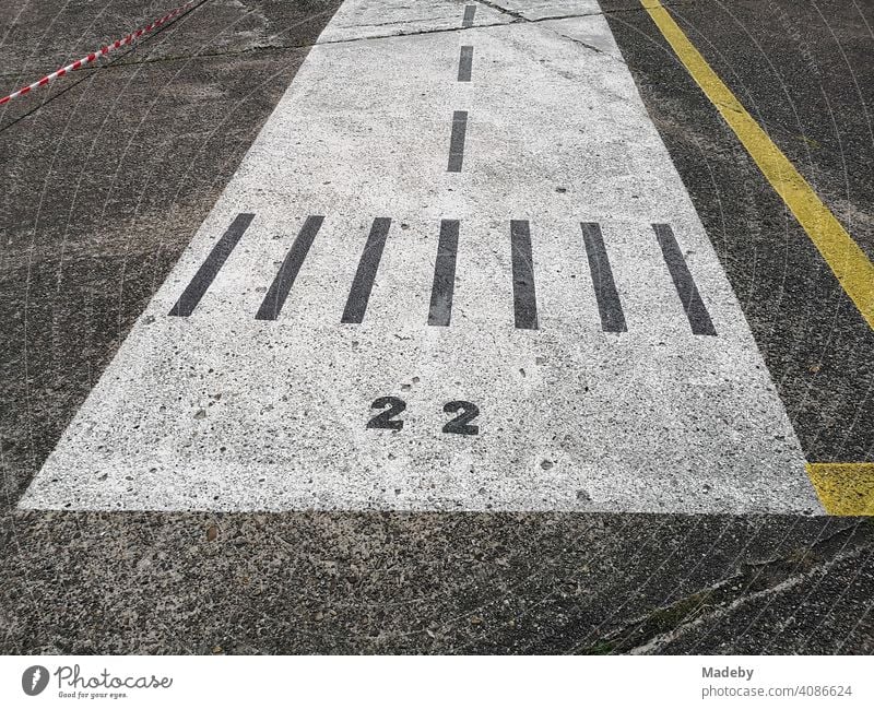 Runway painted on grey concrete for children in sunshine at airfield festival in Oerlinghausen near Bielefeld at Hermannnsweg in the Teutoburg Forest in East Westphalia-Lippe