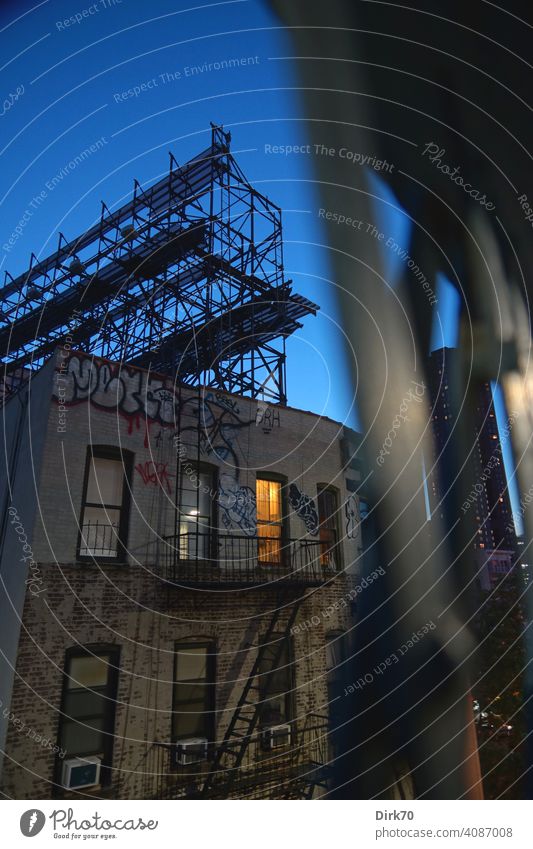 Backstreets in Chinatown - Run-down apartment building in New York with light in a window in House (Residential Structure) Apartment Building New York City