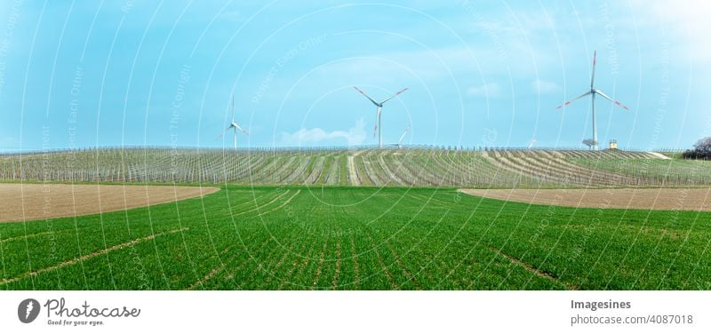 Wind turbines in vineyard, on a hill with a refuge house, vineyard storm. Rhineland-Palatinate, Germany Agriculture Autumn Blue sky Climate Clouds in the sky