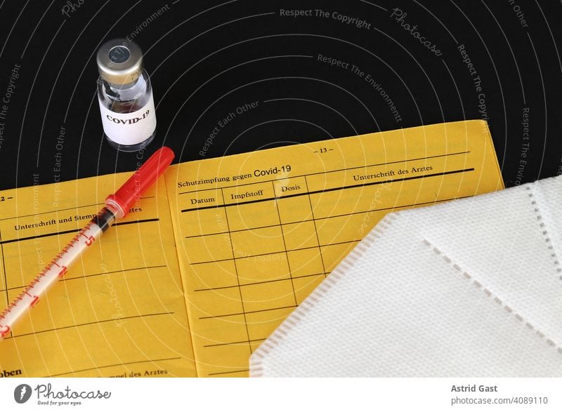 A vaccination against Covid-19 - vaccination certificate, vaccination bottle, syringe and FFP2 mask corona covid-19 vaccine Immunization Vaccination certificate