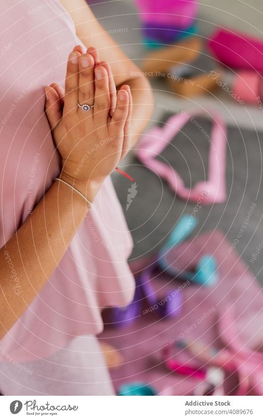 crop attractive woman doing yoga indoors namaste thoughtful position brunette beautiful practicing relaxation meditation harmony sportswear studio fitness