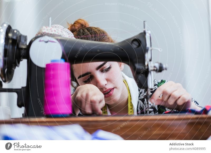 Teenage girl in a sewing school woman class classroom teenager clothing embroidery fabric factory job machine pattern profession seamstress student studio