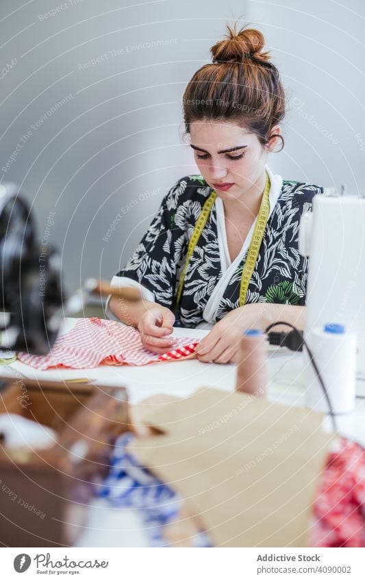 Teenage girl in a sewing school woman class classroom teenager clothing embroidery fabric factory job machine pattern profession seamstress student studio