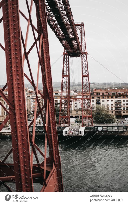 Transporter bridge over river transporter city gondola structure metal architecture water landmark steel construction gray sky weather dull moody building