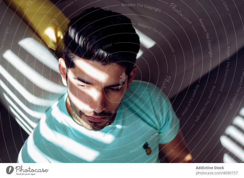 Young sad man sitting on couch at home lonely tired expression sofa young male depressed stressed weary alone serious handsome successful cool stylish hairstyle