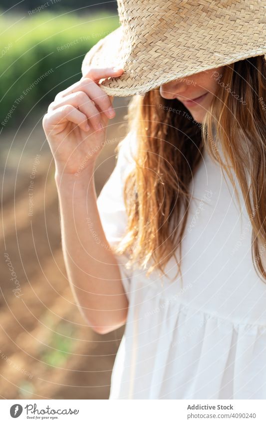 Portrait of anonymous teenager with hat on filed portrait field farm sprouts summer nature sunny daytime catalonia spain anoia girl young rural rustic