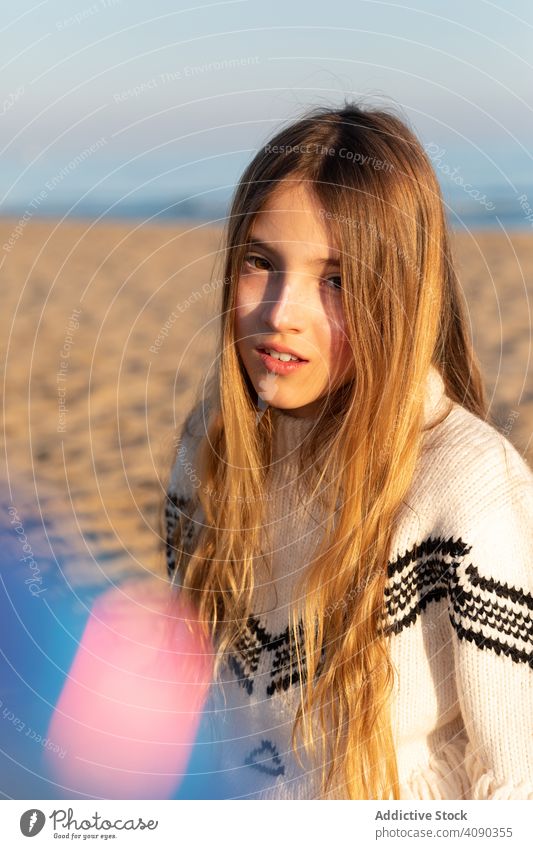 Teen girl looking at camera on beach teen looking through smiling curious piece transparent sweater teenager rest relax lifestyle leisure paint face cute