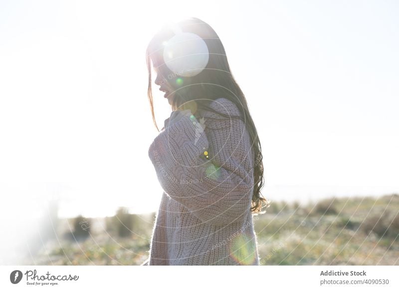 unrecognizable girl standing in sunny day cheerful sky cloudless bright daytime countryside kid child teen weather clear happy joy smiling long hair stylish